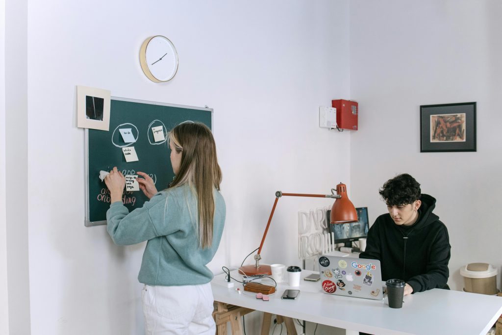 Woman in Gray Long Sleeve Shirt Holding White Ceramic Mug